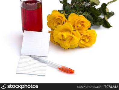 glass of juice, notebook with the handle and a bouquet of roses