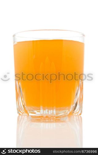 glass of juice on white background with reflection