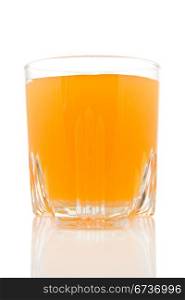 glass of juice on white background with reflection