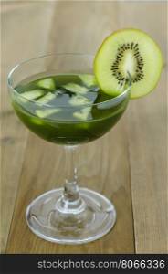 glass of kiwi juice . glass of kiwi juice with fresh fruits on wooden table