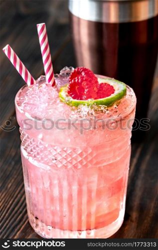 Glass of Knickerbocker cocktail made of rum, lime juice, orange curacao and raspberry syrup