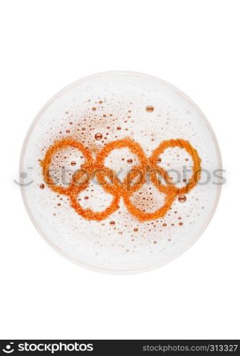 Glass of lager ale beer top with olympics shape on white background top view