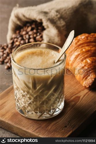 Glass of latte coffee with croissant