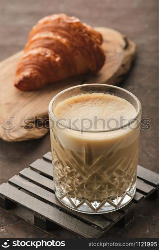 Glass of latte coffee with croissant