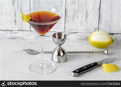 Glass of Martinez cocktail garnished with lemon zest