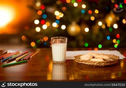 Glass of milk and cookies waiting for Santa Claus at Christmas eve
