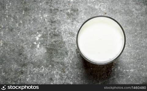 glass of milk. On the stone table. glass of milk.