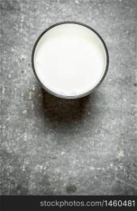 glass of milk. On the stone table. glass of milk.
