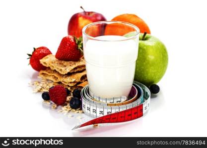Glass of milk or kefir, fruits, crispbreads, berries and measuring tape isolated on white