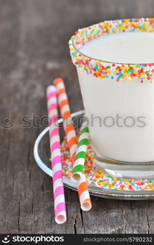 Glass of milk with striped straws