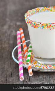 Glass of milk with striped straws