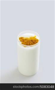 Glass of milk with turmeric powder