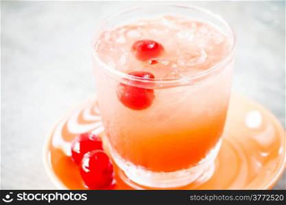 Glass of mix fruits juice soda with cherry