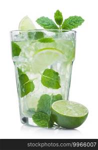 Glass of Mojito summer alcoholic cocktail with ice cubes mint and lime on white background with raw lime and mint leaf