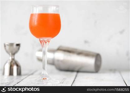Glass of Monkey Gland cocktail on white background