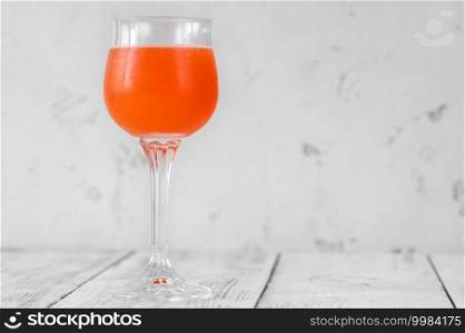 Glass of Monkey Gland cocktail on white background  