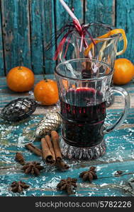 glass of mulled glass of mulled wine with spices in retro style wine