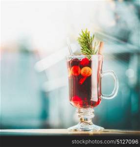 Glass of mulled wine at winter day background, front view, square