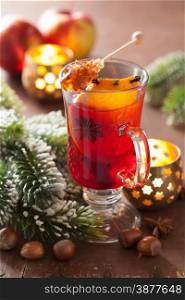 glass of mulled wine with orange and spices, christmas decoration