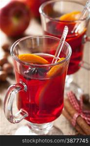 glass of mulled wine with orange and spices, christmas decoration