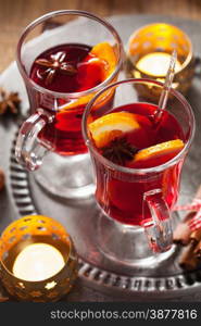 glass of mulled wine with orange and spices, christmas decoration