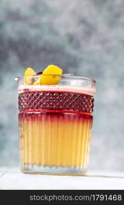 Glass of New York Sour garnished with cocktail cherry and lemon peel