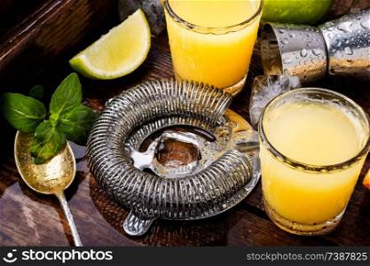 Glass of orange drink.Alcoholic drinks on rustic wood background.Drink background. Fresh cocktail drinks