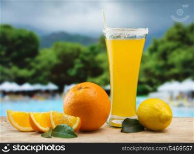Glass of orange juice on a beach table