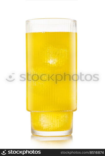 Glass of orange soft drink with ice cubes and bubbles on white.