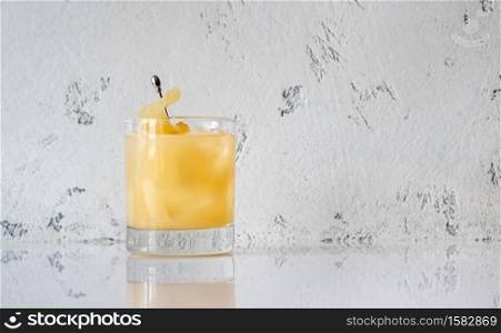Glass of Penicillin cocktail on white background