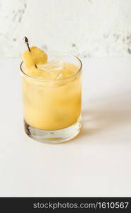 Glass of Penicillin cocktail on white background