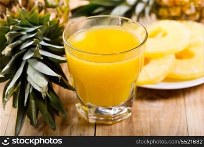 glass of pineapple juice with fresh fruits