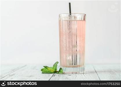 Glass of pink gin and tonic cocktail
