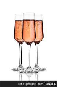 Glass of pink rose champagne with bubbles on white background with reflection