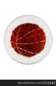 Glass of red ale beer top with basketball shape on white background top view