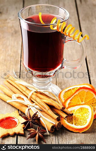 Glass of red mulled wine on wooden table