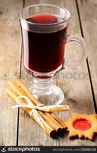 Glass of red mulled wine on wooden table