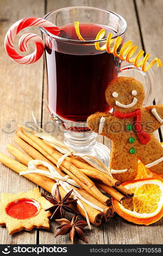 Glass of red mulled wine on wooden table