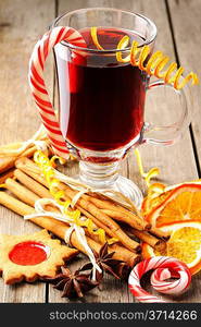 Glass of red mulled wine on wooden table