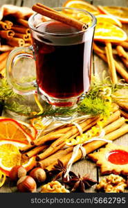 Glass of red mulled wine on wooden table