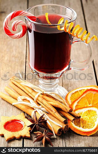 Glass of red mulled wine on wooden table