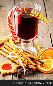 Glass of red mulled wine on wooden table