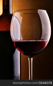 Glass of red wine and bottle close-up