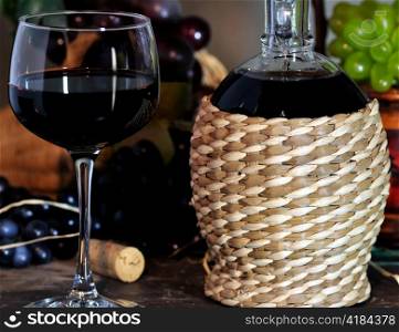 glass of red wine and decorative bottle