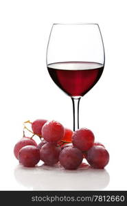 glass of red wine and grapes isolated