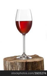 Glass of red wine on stump isolated on white