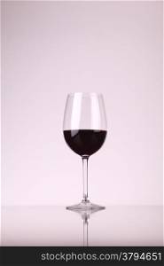 Glass of red wine over a white background