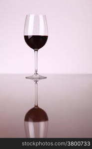 Glass of red wine over a white background