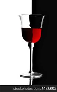 Glass of red wine over contrast black and white background