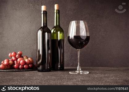 Glass of red wine with bunch of grapes
